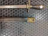 a knife that is laying on top of a piece of metal