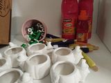 a box of toothbrushes and toothpaste cups on a table