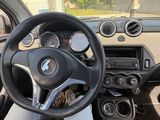 someone is sitting in the driver ' s seat of a car with their feet on the steering wheel