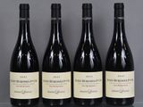 three bottles of wine are lined up on a glass table