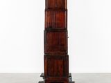 an image of a tall wooden cabinet on wheels in a room