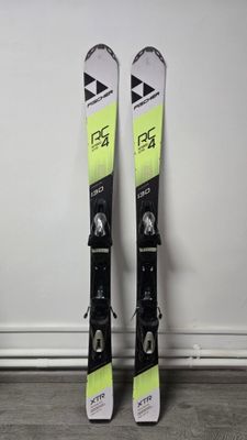 pair of skis leaning up against a wall in a room