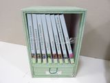 a green box with a bunch of books inside of it
