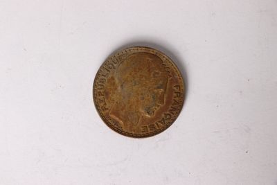 a close up of a coin on a white surface with a white background