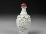 an image of a white vase with a red lid sitting on a table