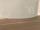 a white bucket sitting on top of a cardboard box
