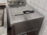 a silver stove and a silver oven in a kitchen