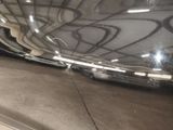 a reflection of a car in a mirror on the side of the road