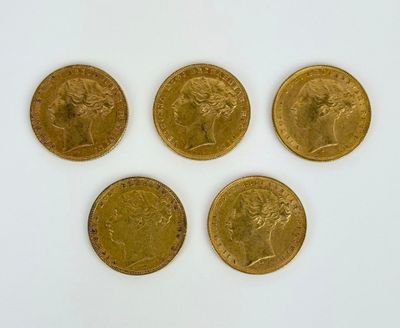 four gold sovereigns of different sizes and shapes on a white surface