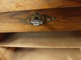 a wooden drawer with a metal latch on it