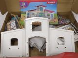 a cardboard box with a doll house inside of it