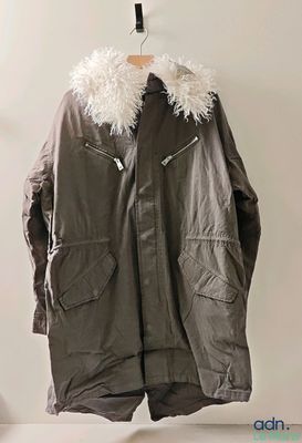 a jacket hanging on a hanger on a wall
