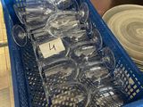 a blue basket full of empty plastic cups on a table