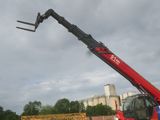 a red crane that is sitting on a truck