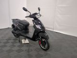 a black scooter parked in a room with a checkered floor