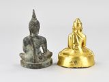 pair of small buddha figurines on a white background