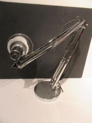 a lamp that is sitting on a table next to a wall