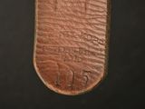 an old brown leather case with the number one on it