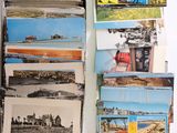 a lot of postcards on a table with a bunch of them