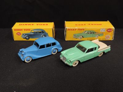 three toy cars are sitting next to each other on a black surface