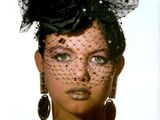 black and white photo of a woman wearing a veil and earrings