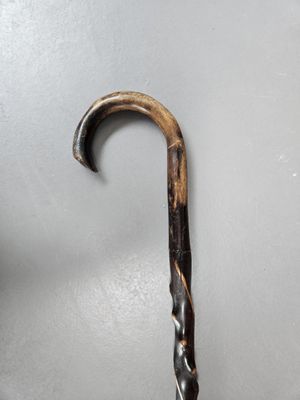 a close up of a wooden stick with a metal handle