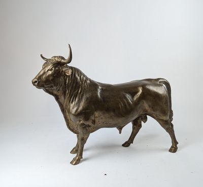 bronze statue of a bull on a white background