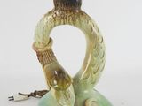 a green lamp with a bird on top of it