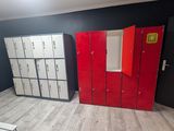 several lockers are lined up in a room with red doors
