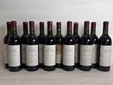 six bottles of wine are lined up in a row on a table