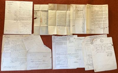 several old papers are sitting on top of a table