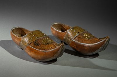 two wooden shoes that are sitting on a table
