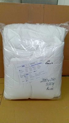 a close up of a bag of white toilet paper on a table