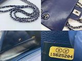 a blue purse that has a tag on it