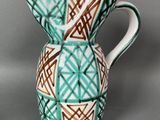 a blue and white vase with a brown design on it