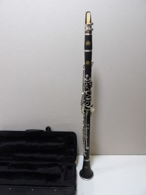 a clarinet that is sitting on a table next to a case