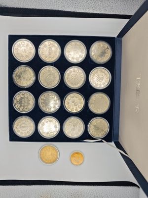 a lot of coins in a box on the table