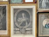 many framed pictures of men and women on the wall