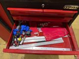 a red tool box with tools in it on the floor