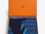 an orange box with a pair of socks in it
