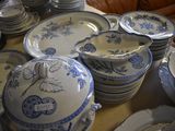a lot of blue and white plates and bowls on a table