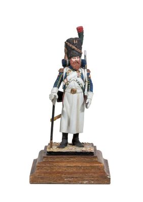 figurine of a soldier in uniform with a sword on a wooden base