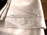 a stack of folded linens on a wooden table