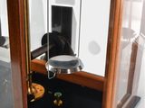 a glass display case with a clock inside of it