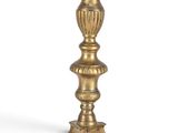 a close up of a gold candle holder on a white background