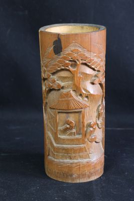 un vase en bois avec des sculptures sur un fond noir
