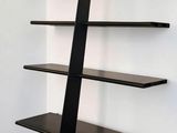 an image of a black book shelf in a room