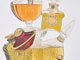 bottles of perfume are stacked on top of each other on a white surface