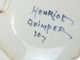 a white bowl with writing on it sitting on a table
