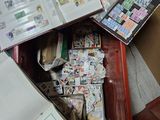 a suitcase full of stamps and a book on the floor